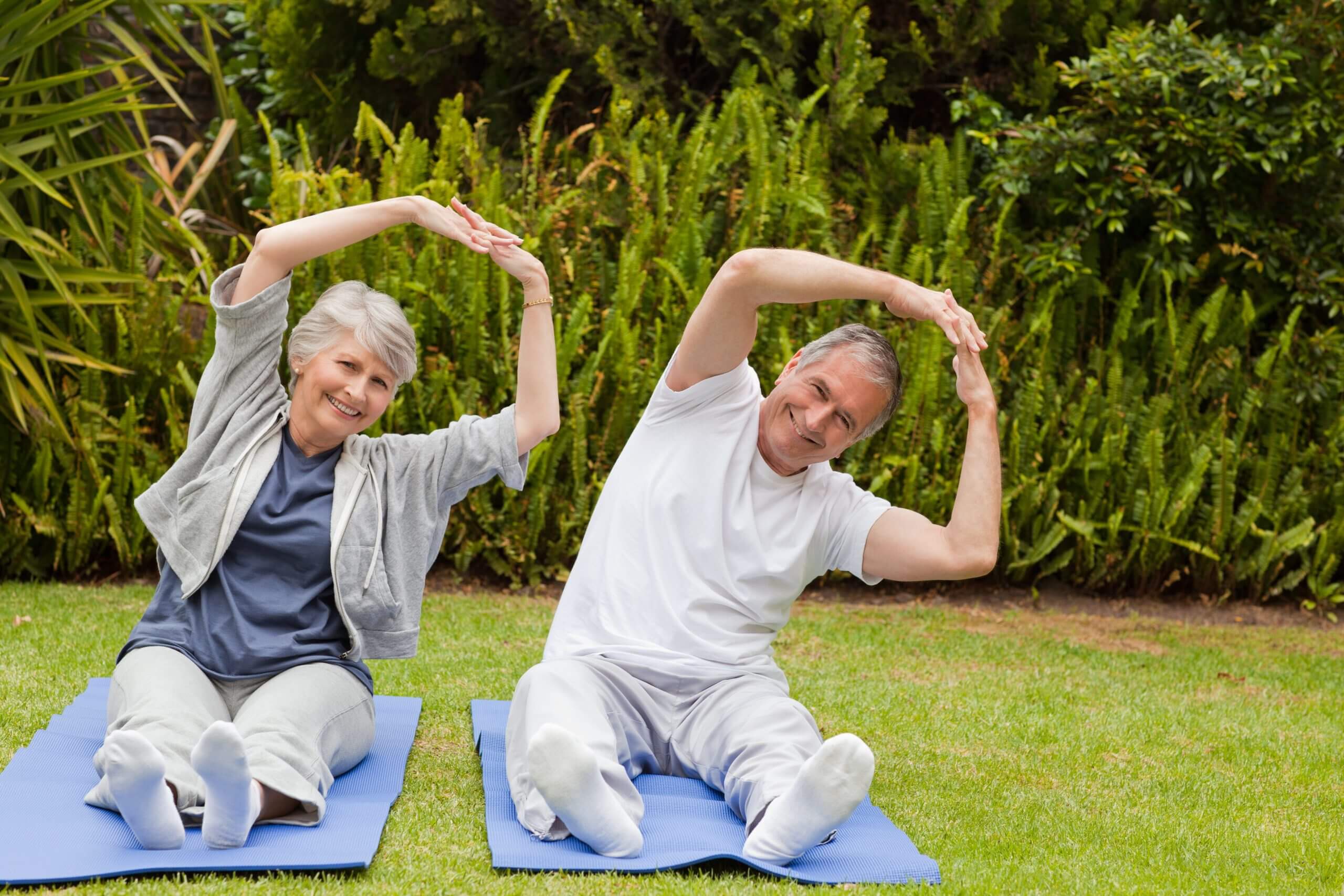 Senior couple doing their streches in the garden