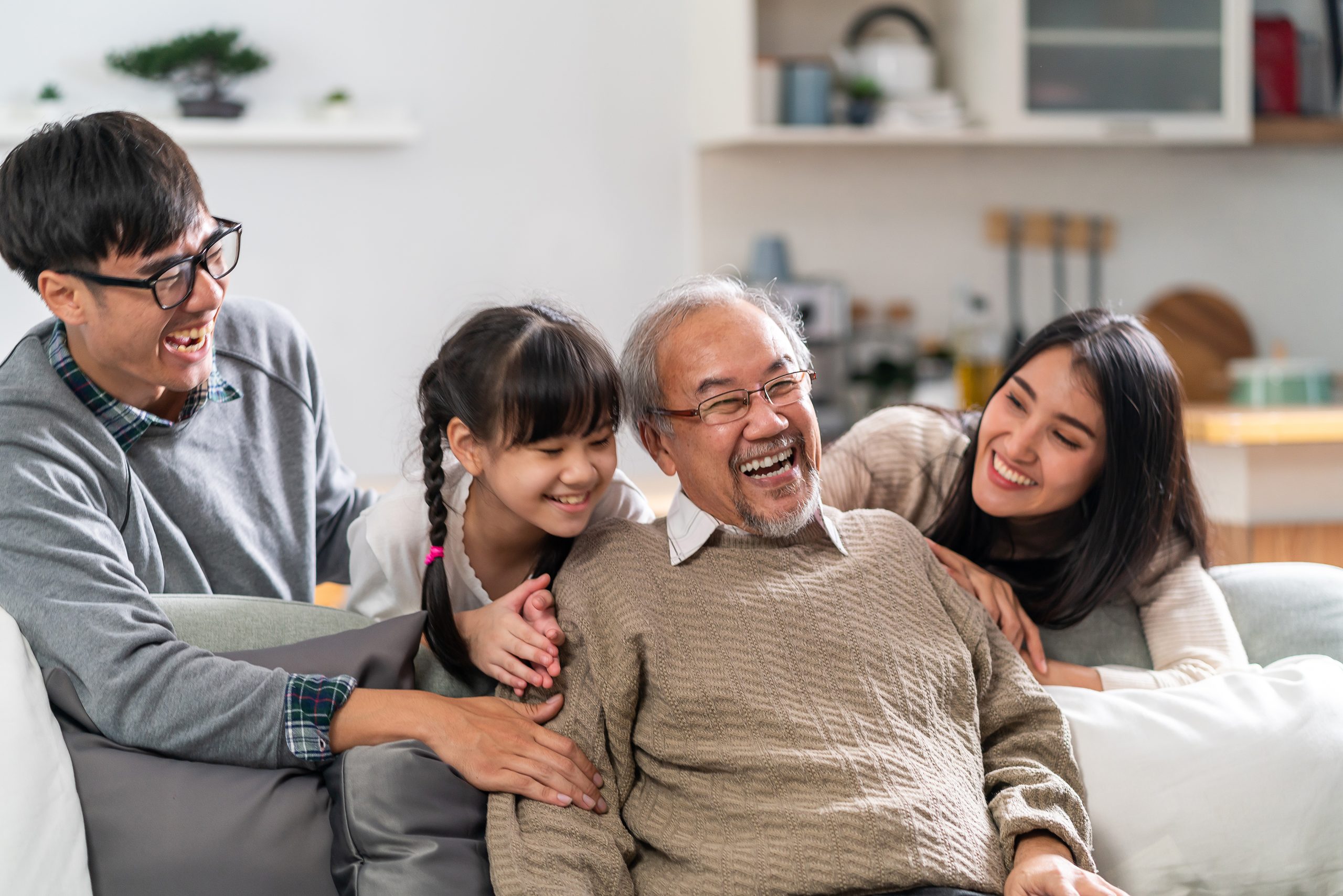 Happy multigenerational asian family portrait in living room
